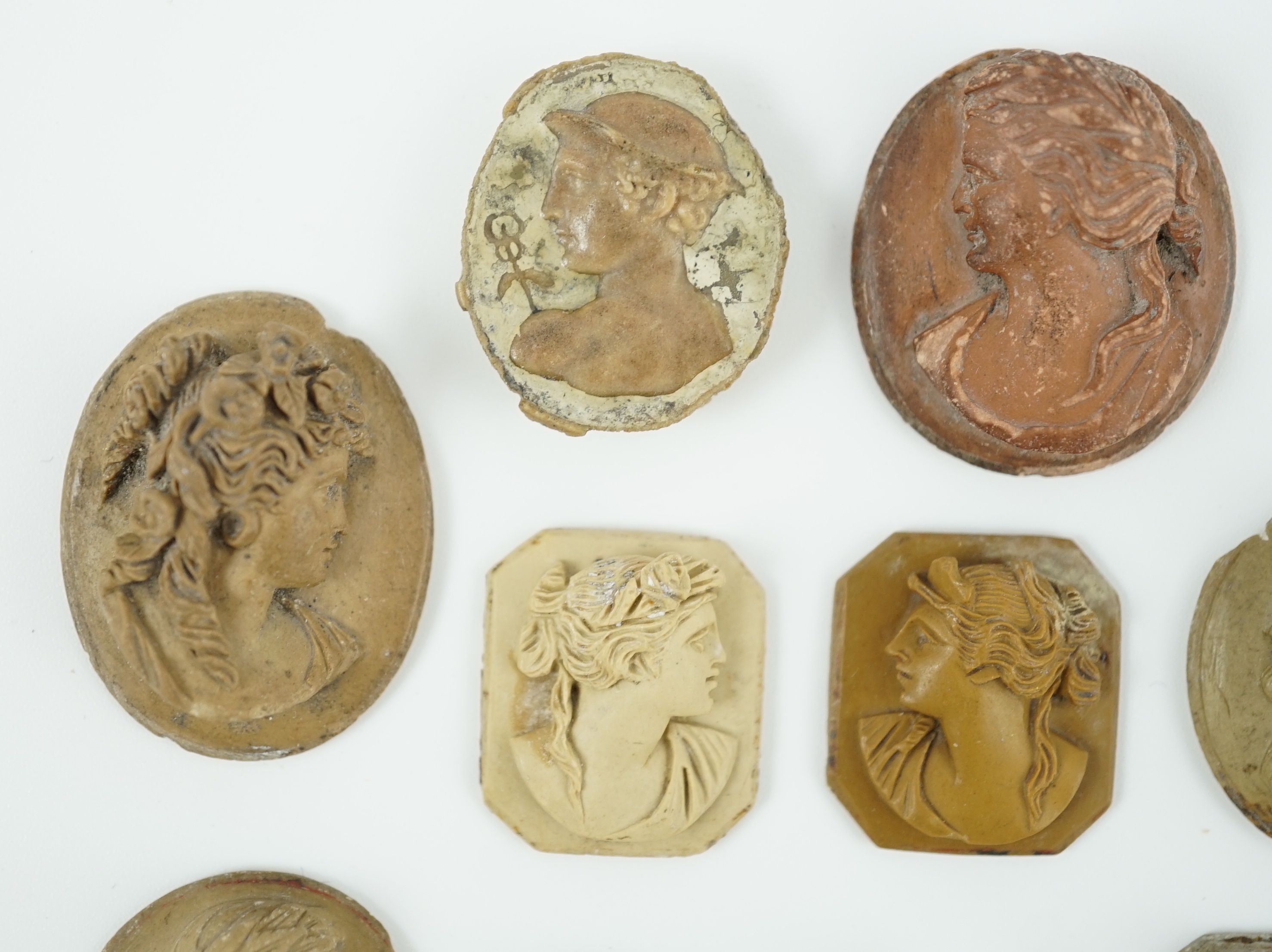 An antique hardstone cameo of Hermes and nine Italian lava cameos largest 2.75 x 2.25cm.